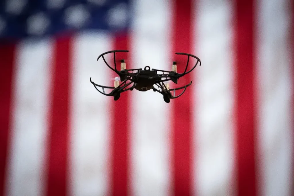 A drone hovers infront of a USA flag at the PA State Capitol during an II4T STEM event..